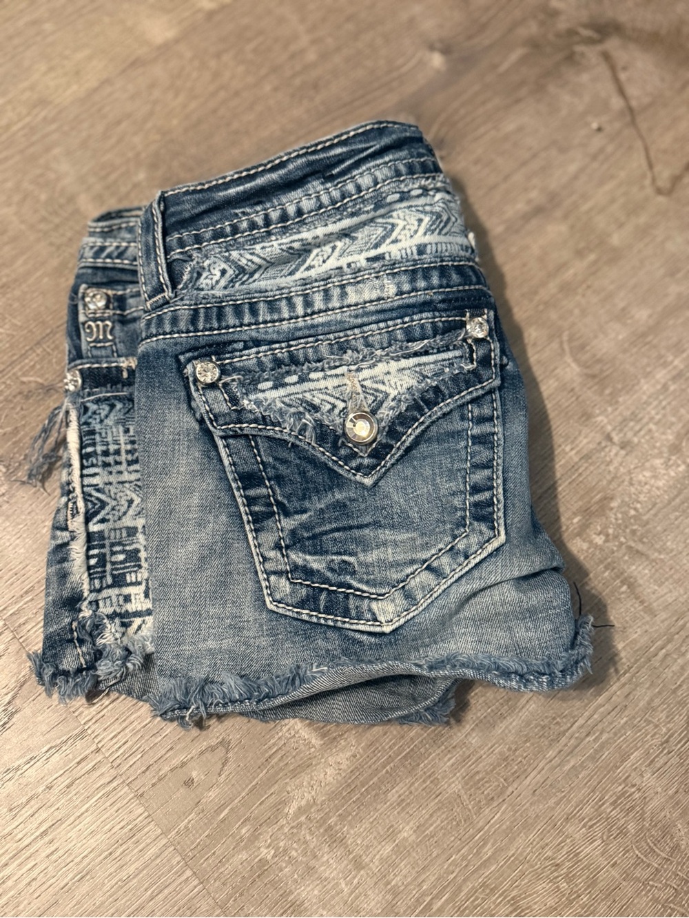 Signature Distressed Light Blue Denim Shorts with Embellished Pockets